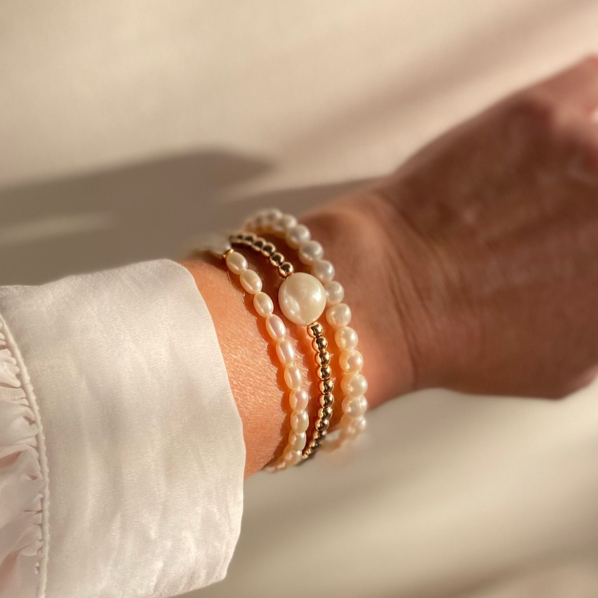 Round Freshwater Pearl and Gold Vermeil Bracelet stacked with other gold and pearl bracelets