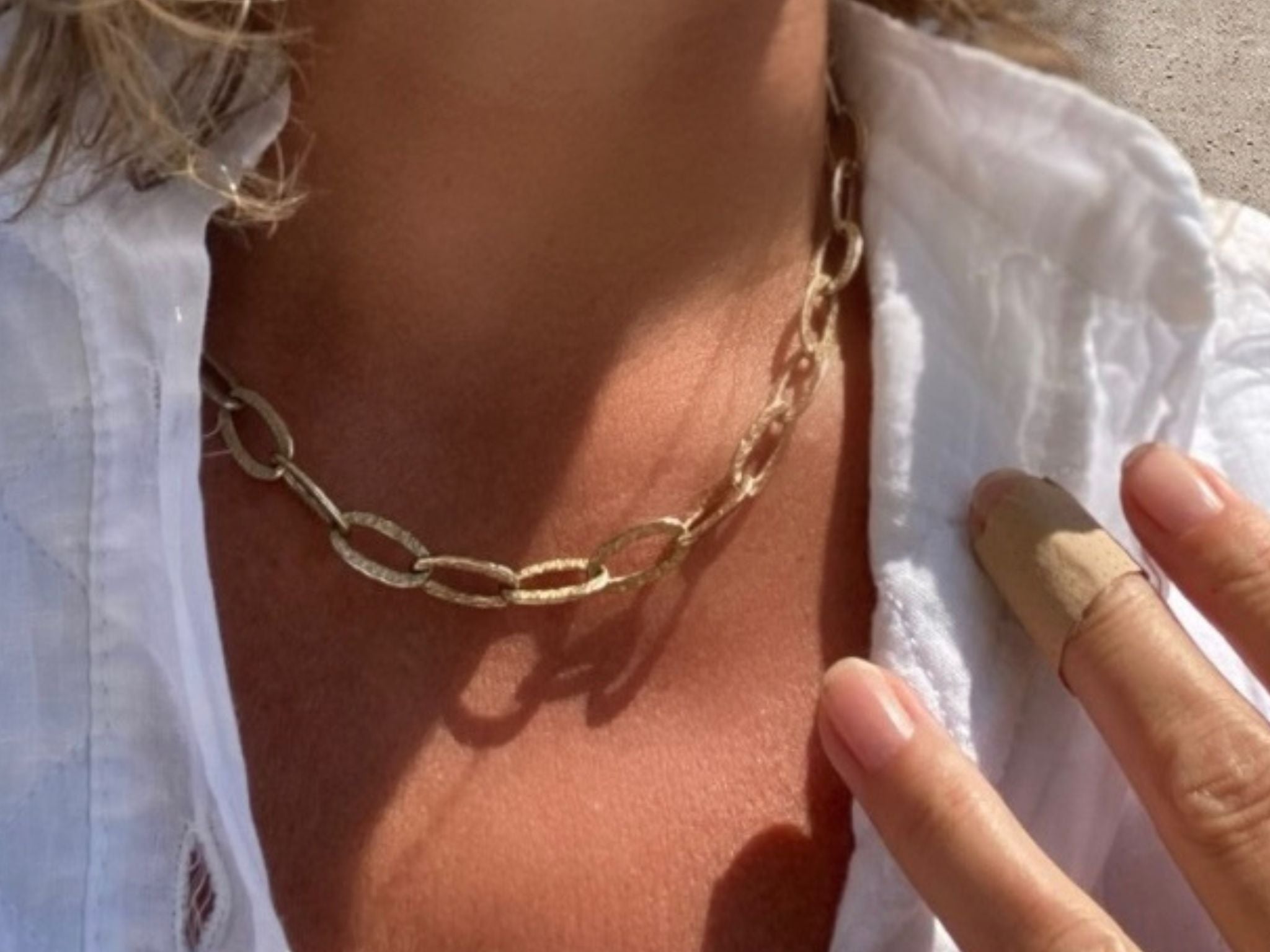 RAW Copenhagen chucky chain gold vermeil necklace modelled on sunkissed skin