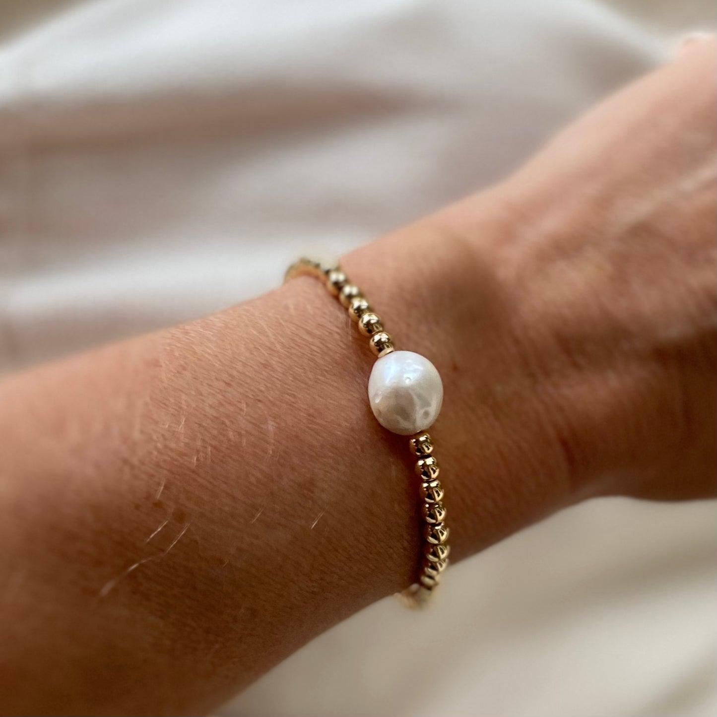 Handmade pearl and gold bracelet, worn solo in image but can be stacked. Handmade in the RAW Copenhagen Studio in Kent, UK. Featuring freshwater pearls, gold vermeil, and baroque pearls for a timeless, minimalist style. Ethically made in the UK.