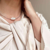 Baroque pearl and labradorite choker modelled against a cream silk dress