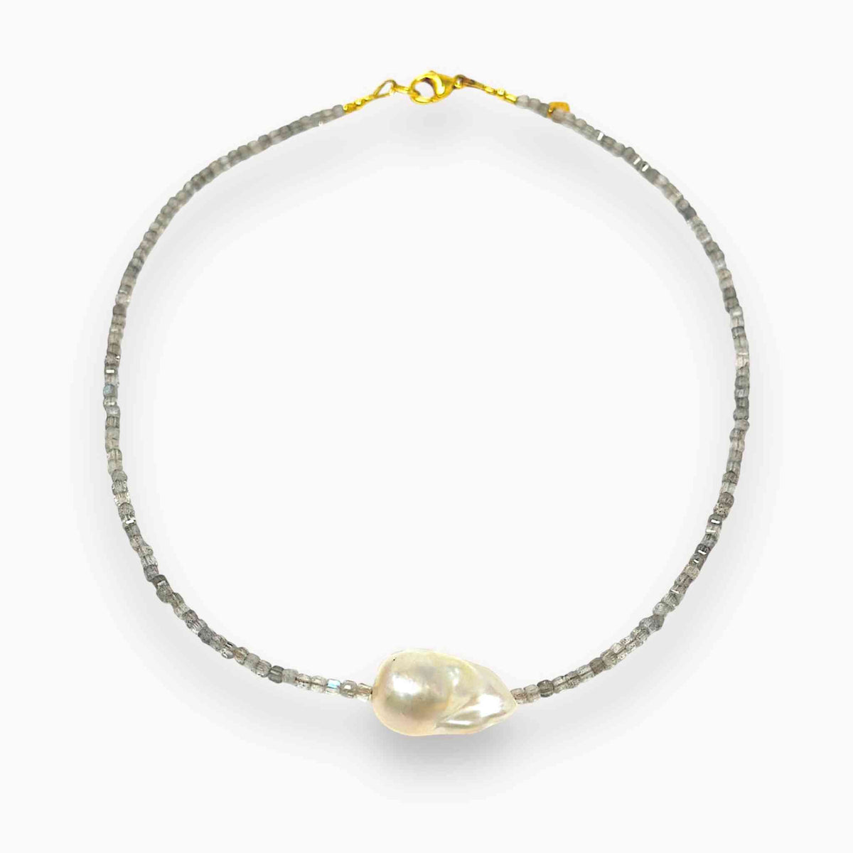 Baroque pearl and labradorite choker laying on cream backdrop