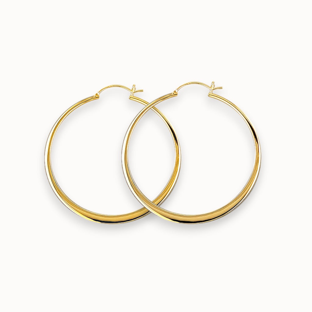 Gold hoop earrings on a white background