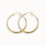 Gold hoop earrings on a white background