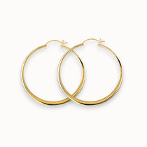 Gold hoop earrings on a white background