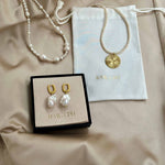 Pearl jewelry set with 'RAW.CPH' branding on a beige fabric background