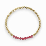 Gold bracelet with pink rhodochrosite beads on a white background