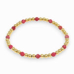 Bracelet with pink beads and gold accents on a white background
