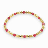 Bracelet with pink beads and gold accents on a white background