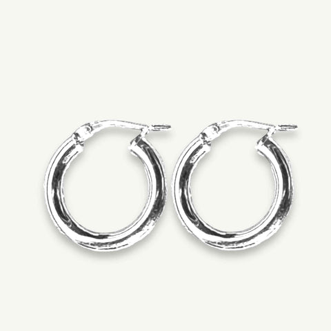 Classic Chunky Silver Hoops from RAW Copenhagen resting on a linen coloured background