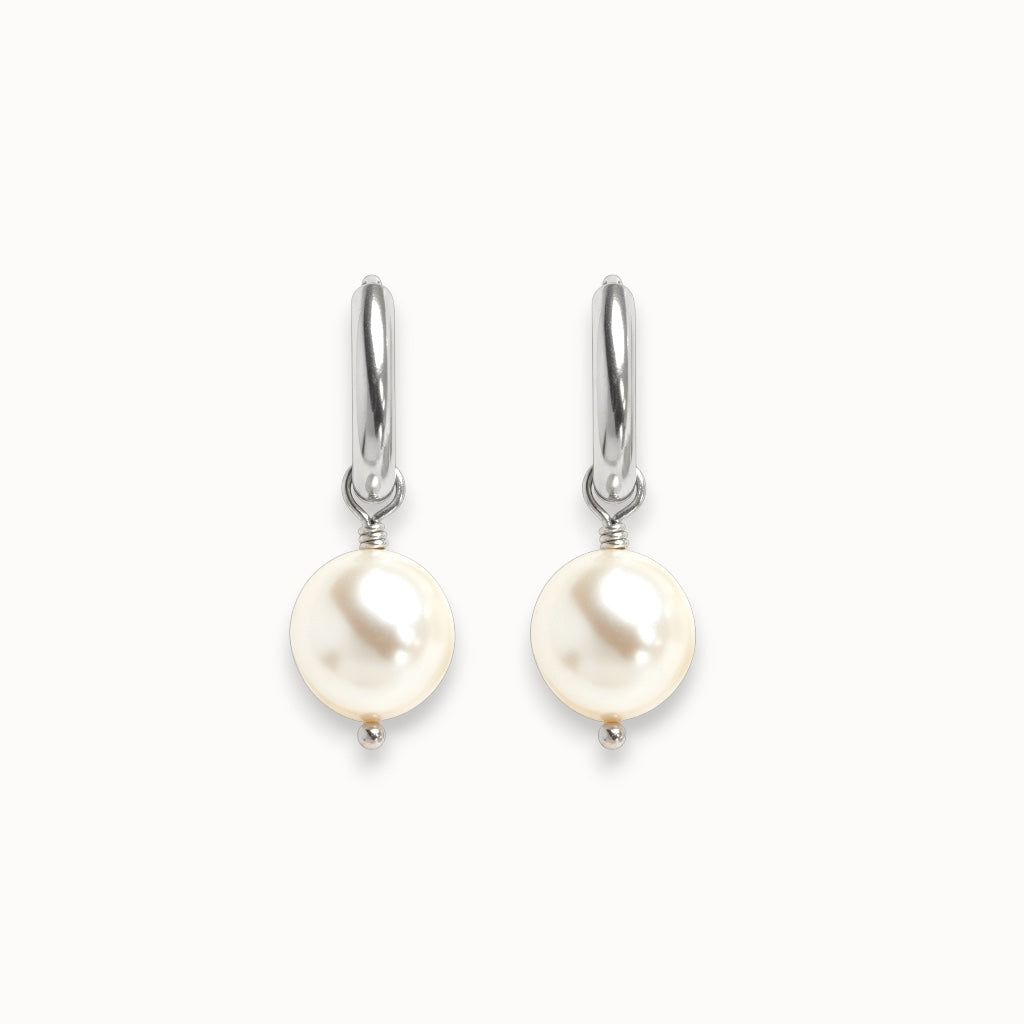 Pearl earrings with silver hooks on a white background