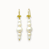 Pair of pearl earrings with gold hooks on a white background