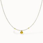 Delicate pearl Necklace with a gold shell pendant on a white background