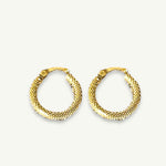 Delicate small gold hoops resting on a linen collared background