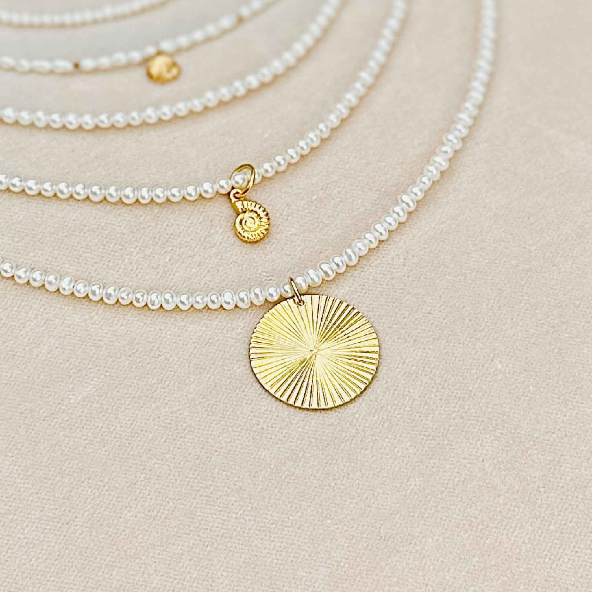 A selection of some of  RAW Copenhagen delicate pearl necklaces with and without pendant
