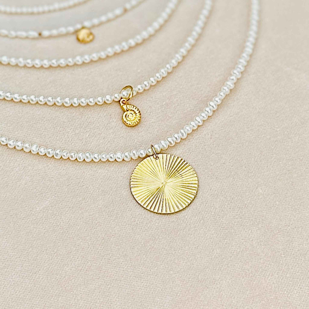 A selection of some of  RAW Copenhagen delicate pearl necklaces with and without pendant