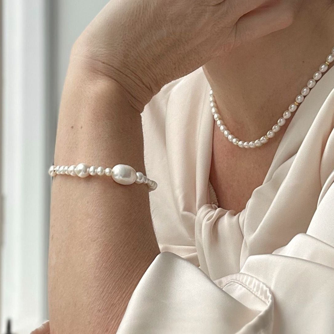Different size pearl bracelet modelled with cream wedding dress 