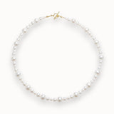 Pearl necklace with a gold clasp on a white background