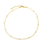 Elegant Pearl Necklace lying flat on a white background made with the highest quality freshwater pearls and 24K gold plated Sterling silver beads 