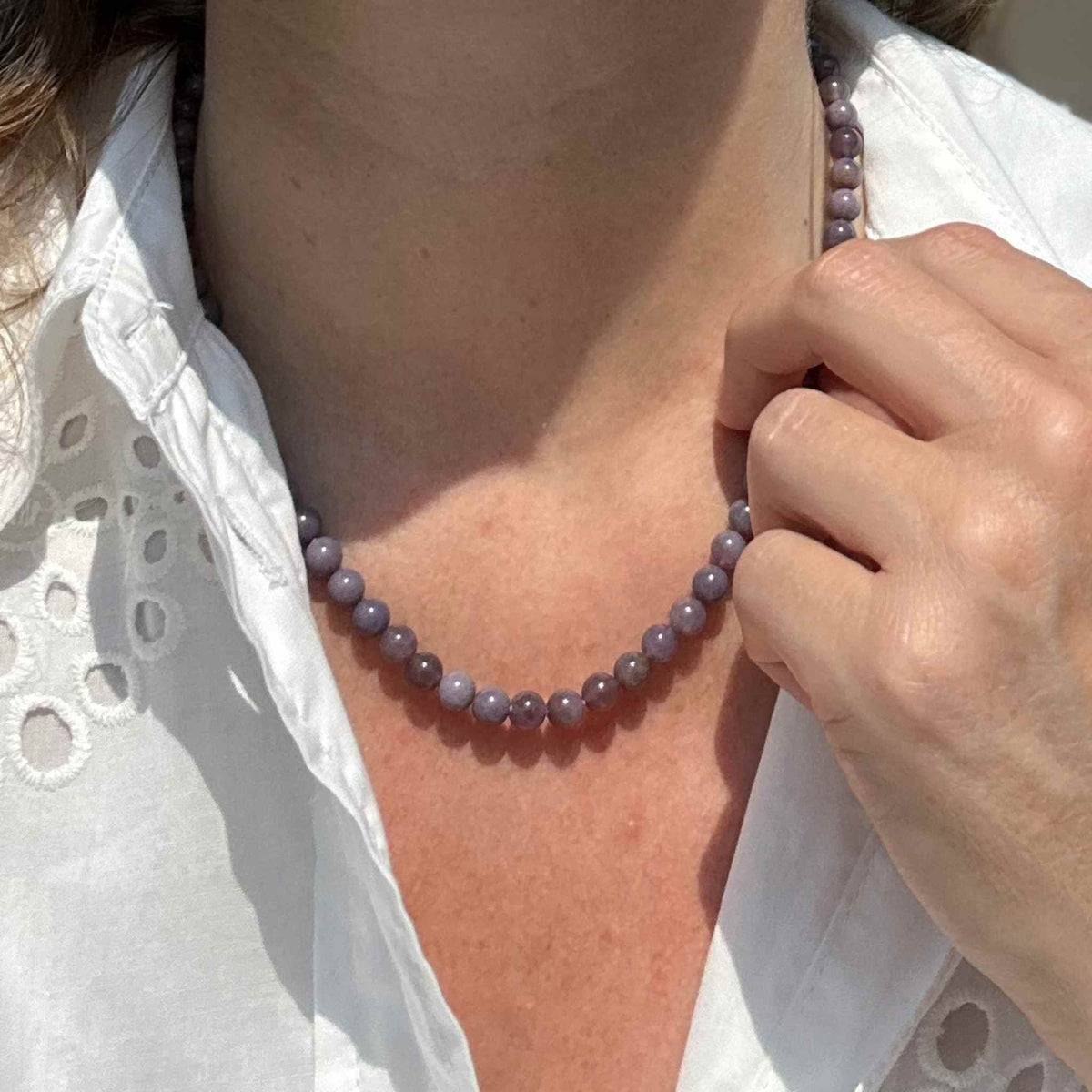 fairtrade chalcedony gemstone necklace modelled against a white dress