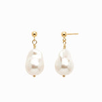 Baroque pearl earrings with gold hooks on a white background