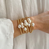 14k gold-filled baroque pearl bracelet by RAW Copenhagen, shown stacked with other freshwater pearl bracelets