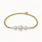Pearl bracelet with gold beads on a white background