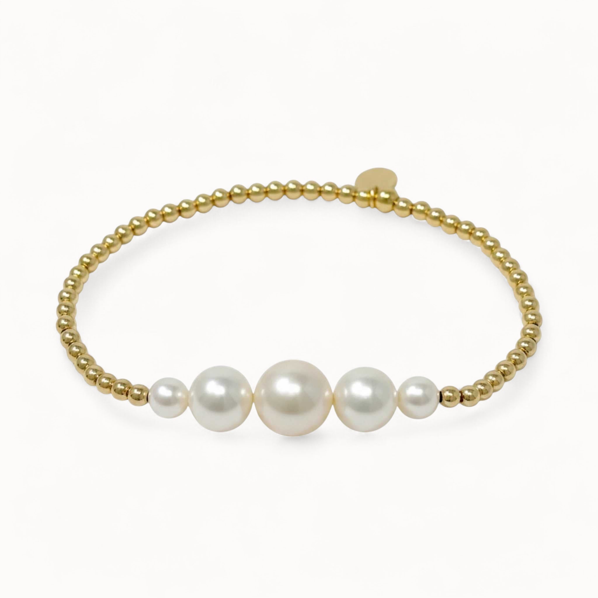 Pearl bracelet with gold beads on a white background