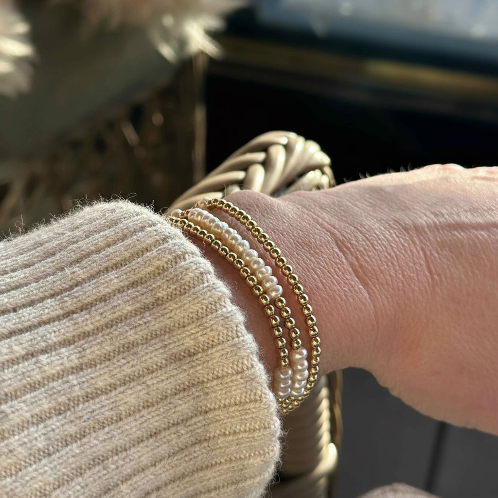 gold wrap bracelet with pearls worn with a cream Isabel Marant jumper 
