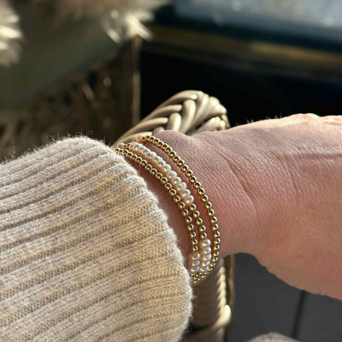 gold wrap bracelet with pearls worn with a cream Isabel Marant jumper 