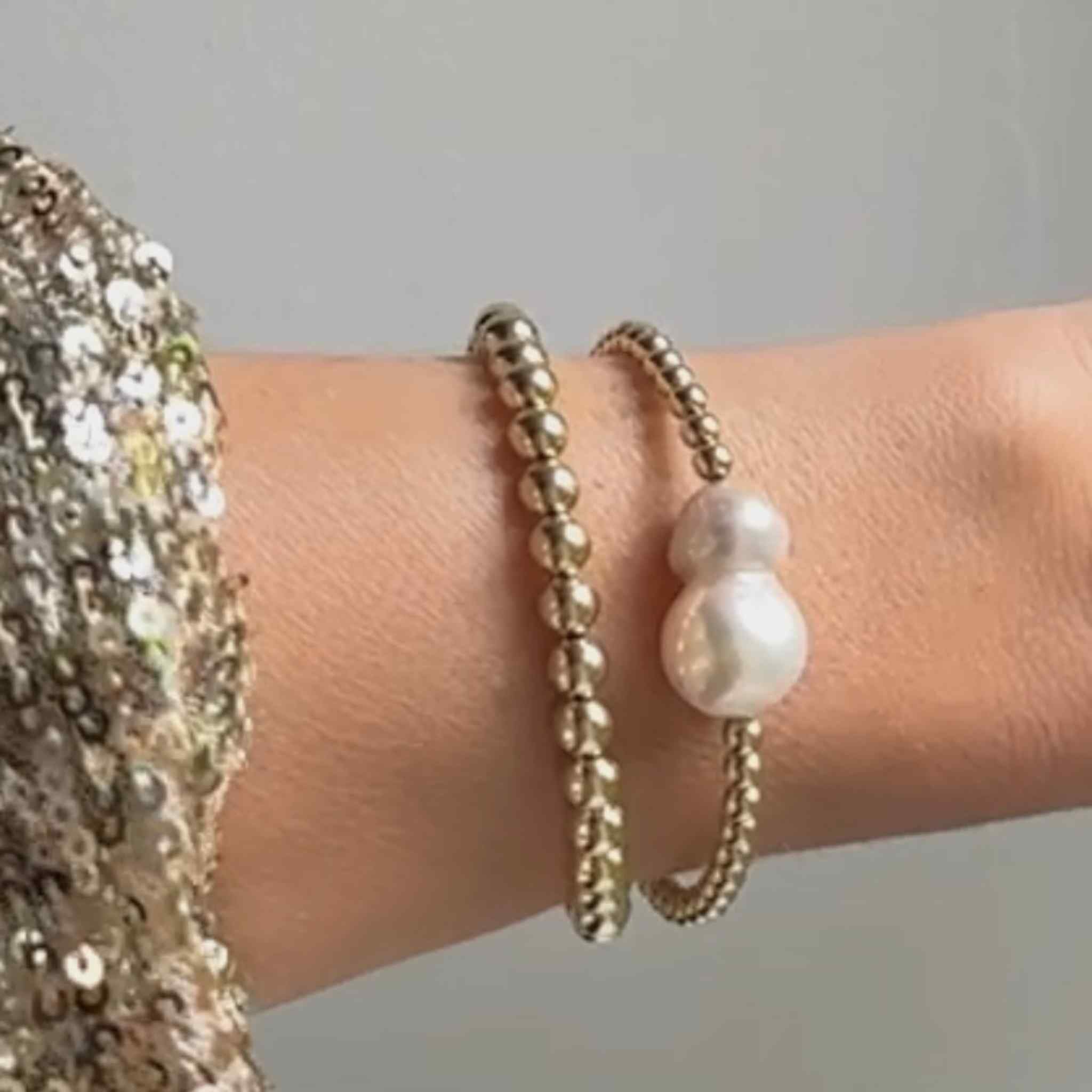 Gold-Filled Double Baroque Pearl Bracelet. Handmade in the UK, worn here with another gold-filled beaded bracelet from RAW Copenhagen