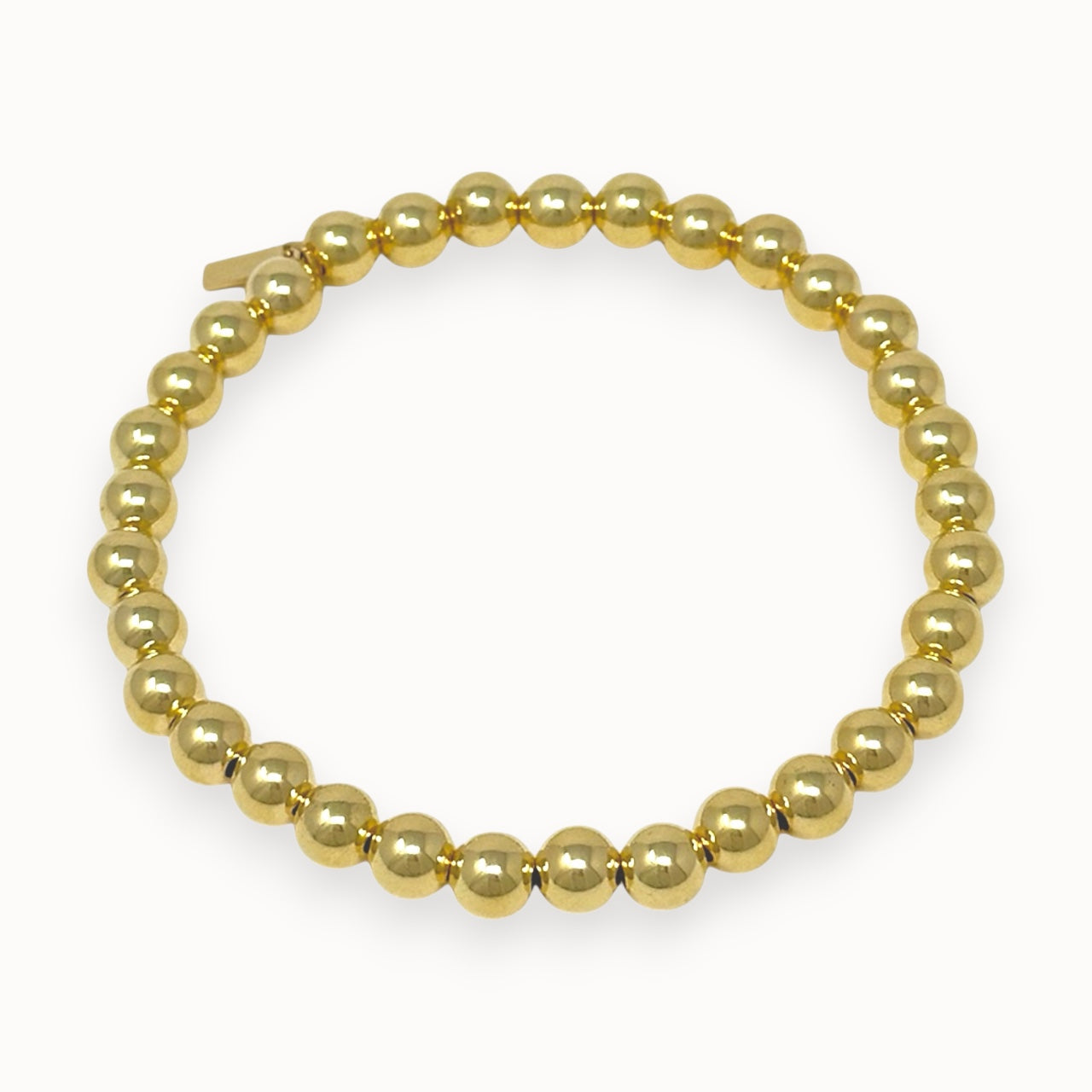 Gold filled beaded bracelet on white background