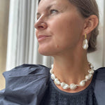 Large baroque Pearl necklace and earrings from RAW COpenhagen modelled with a blue Ulla JOhnson Dress