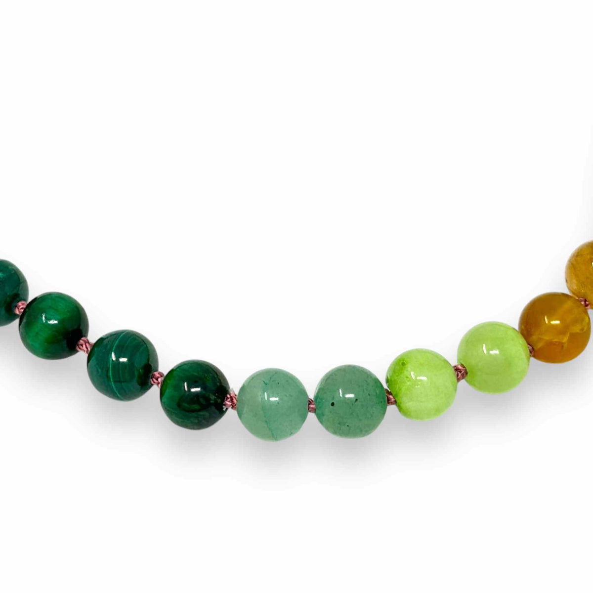 Multicoloured gemstone beaded necklace on white backdrop zoom in
