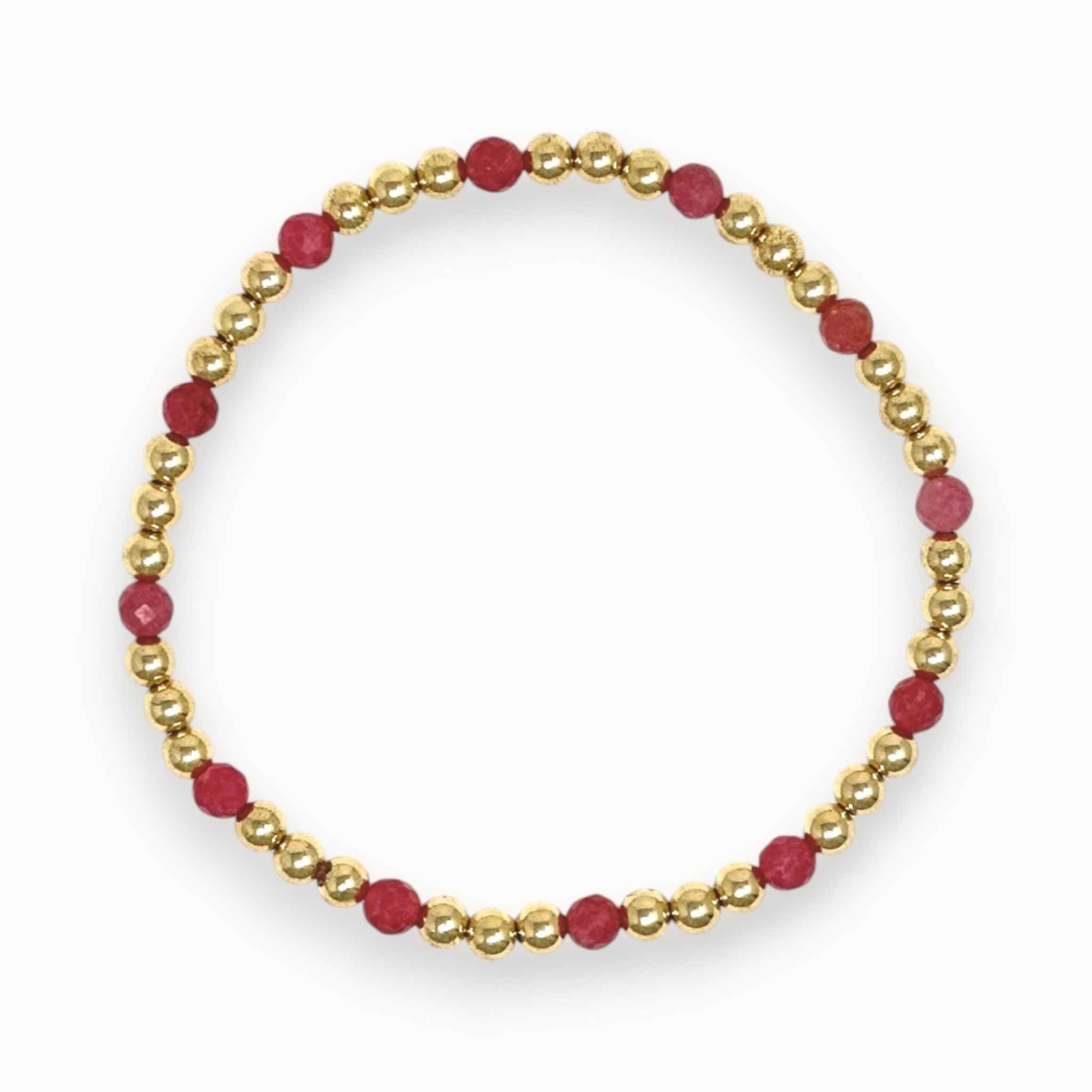 Bracelet with pink rhodochrosite beads and gold chain on a white background