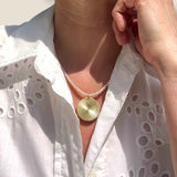 Gold Disc pendant on pearl necklace modelled
