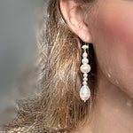 Pearl Drop earrings with different size pearls, longer version modelled