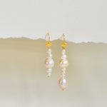 Stunning Scandinavian earring design with mismatched pearl drop on gold ear wire