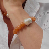 Red aventurine and baroque pearl statement bracelet and necklace modelled