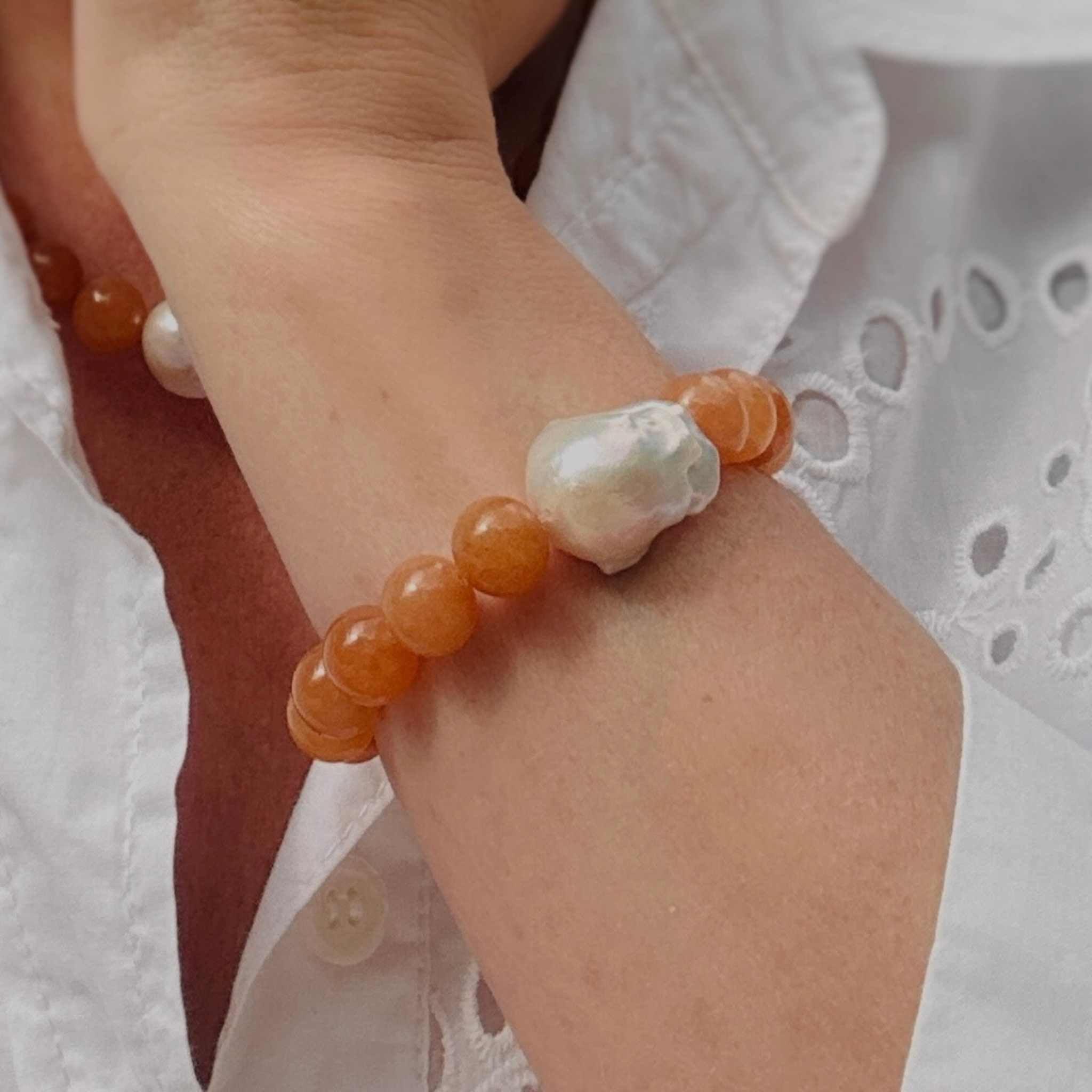 Red aventurine and baroque pearl statement bracelet and necklace modelled