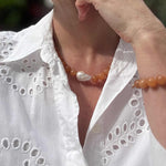 Red aventurine and baroque pearl statement necklace and bracelet modelled