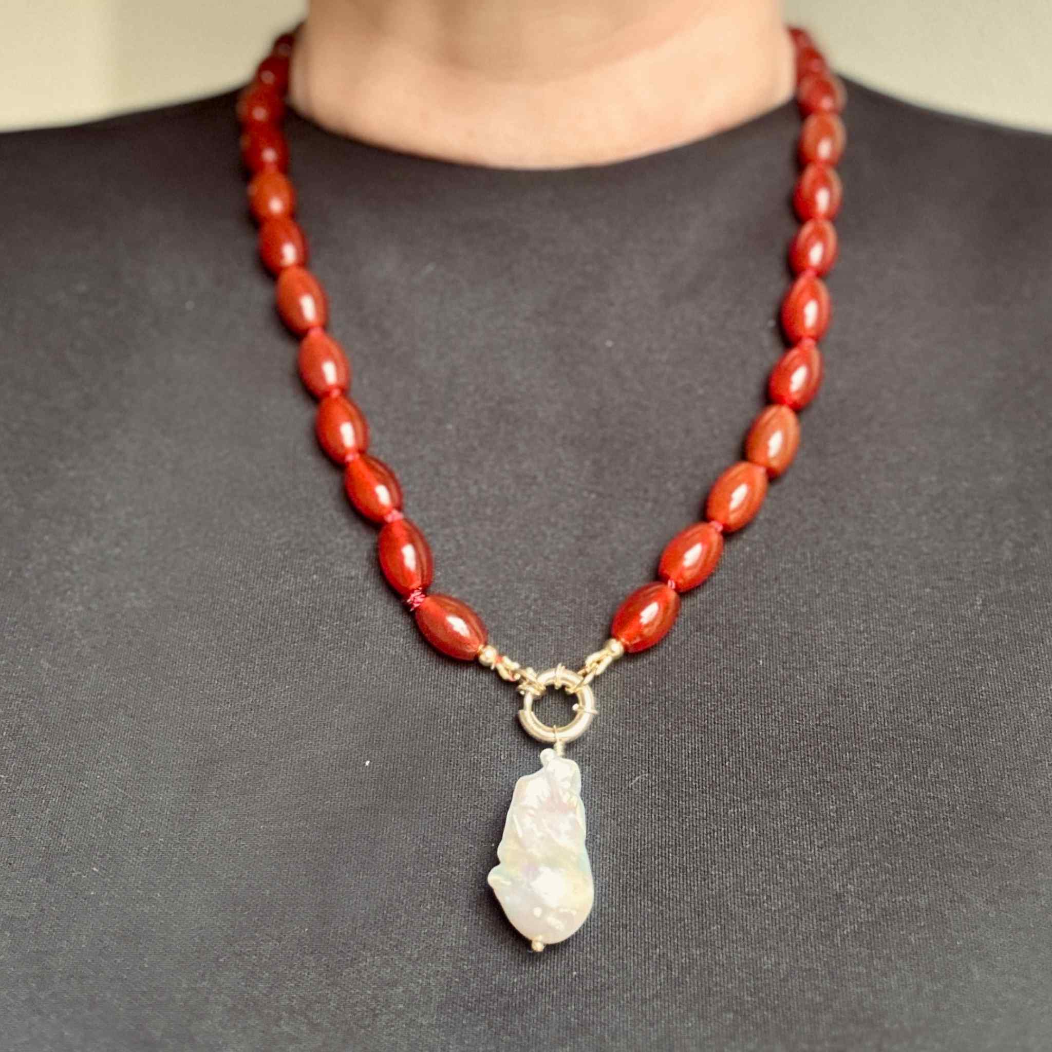 Red chunky gemstone beaded necklace with a large baroque pearl pendant