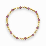 Six mauve ruby and gold beaded bracelet on white background
