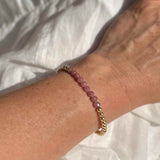 Muave ruby and gold filled beaded bracelet modelled as a single on wrist