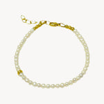 Single strand bracelet of roundish freshwater pearls with delicate gold accent bead and a lobster clasp closure, a classic elegant design