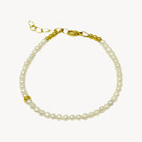 Single strand bracelet of roundish freshwater pearls with delicate gold accent bead and a lobster clasp closure, a classic elegant design
