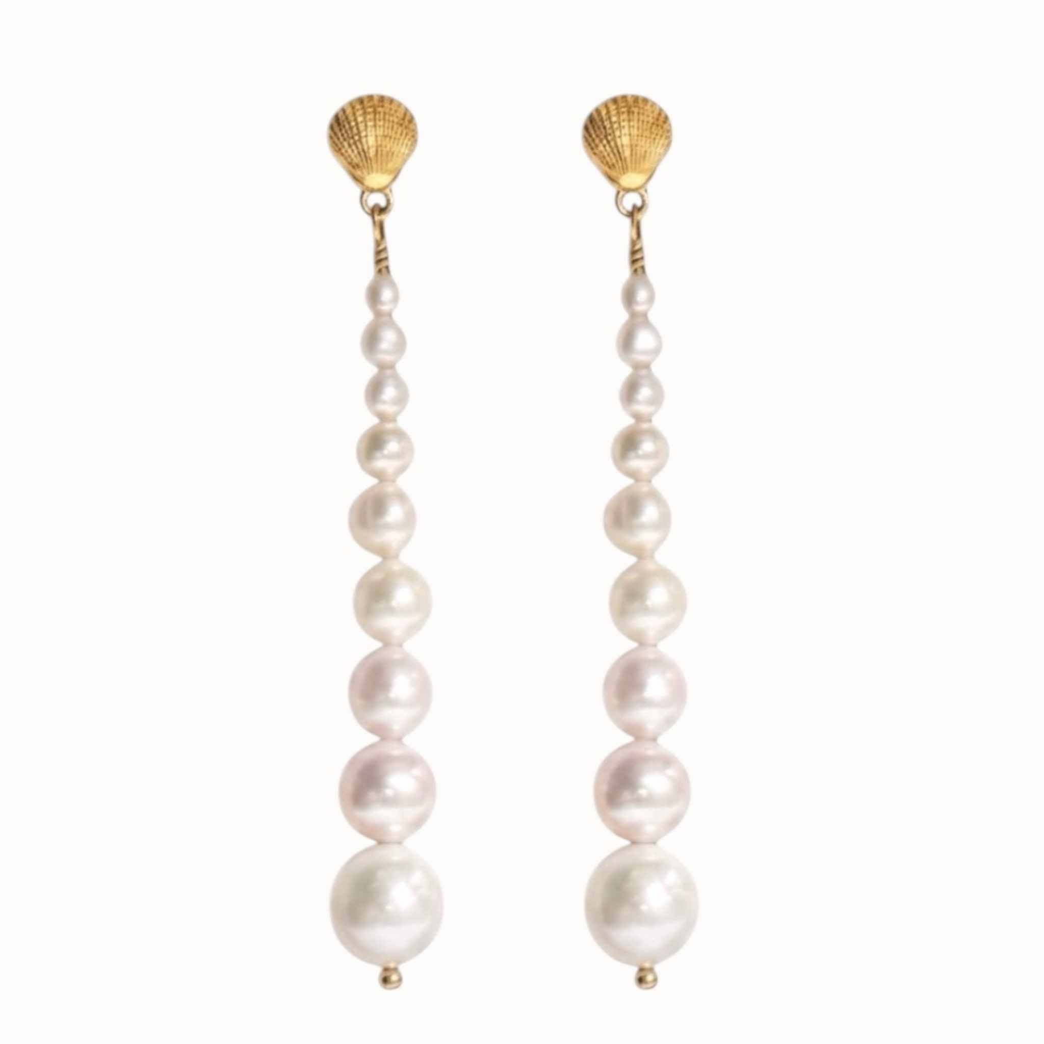 Pair of graduated pearl earrings with gold vermeil studs on a white background