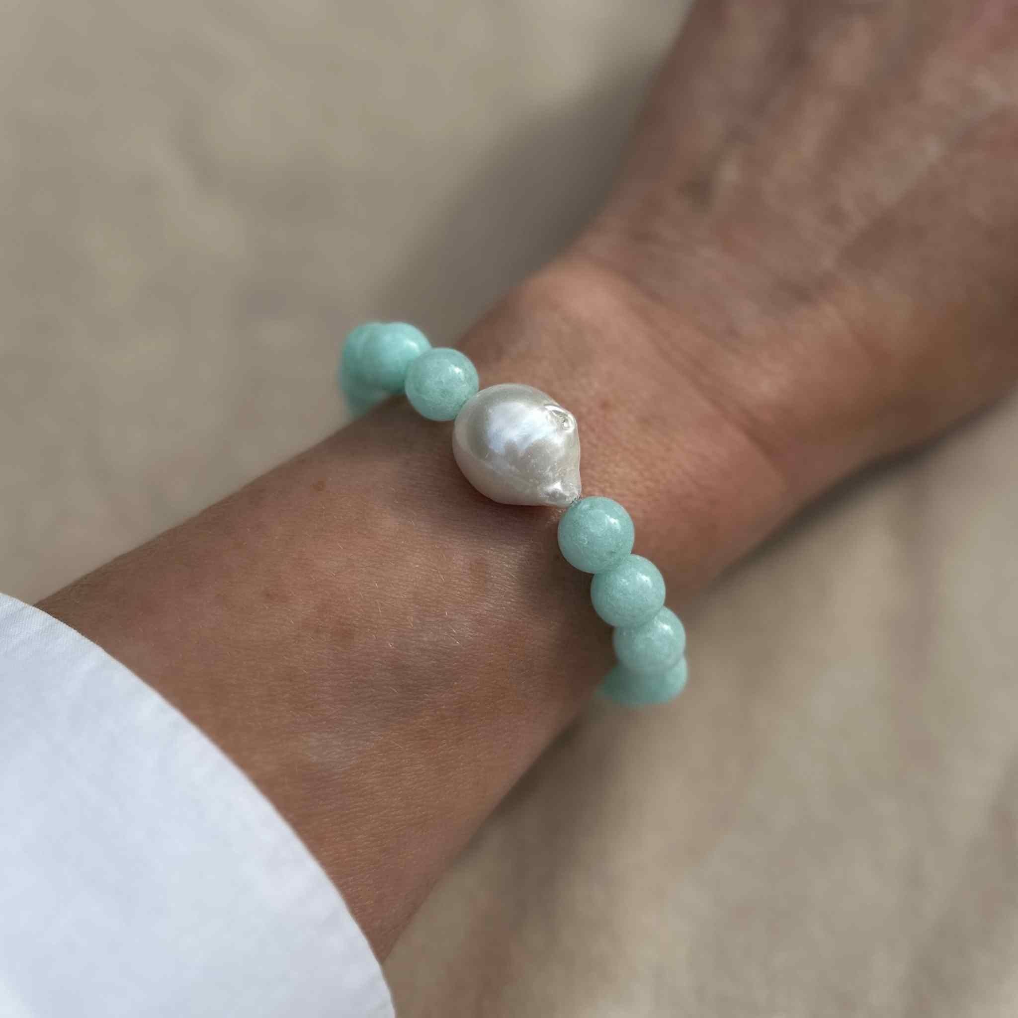 Turquoise Jade and Baroque Pearl Statement Bracelet modelled against sunkissed skin
