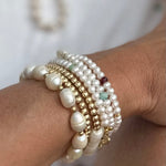 Triple wrap pearl bracelet and necklace in one with gemstone and gold vermeil accent, modelled with other RAW gold and pearl bracelets