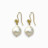 Pair of pearl earrings with gold hooks on a white background