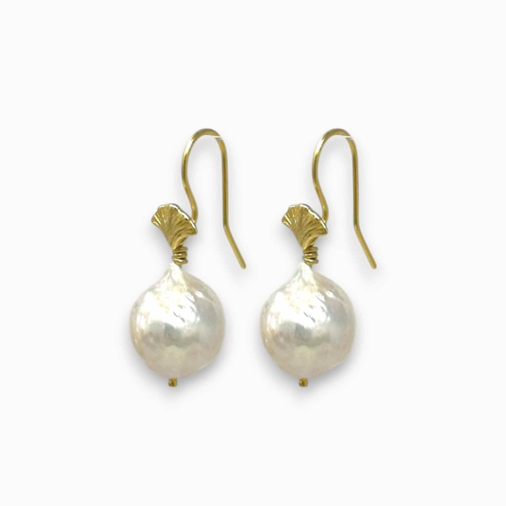 Pair of pearl earrings with gold hooks on a white background